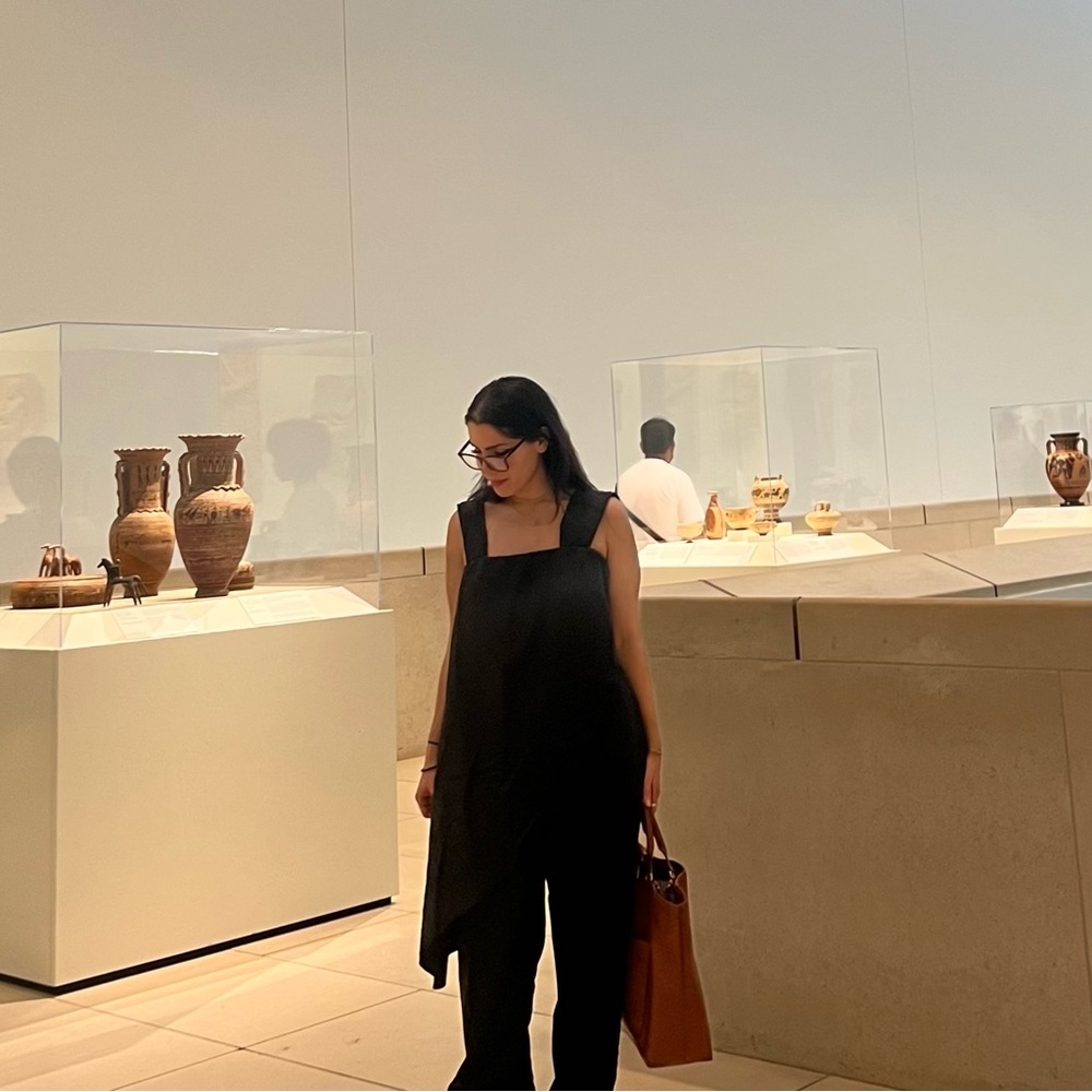 Black jumpsuit with square neckline and asymmetrical overlay